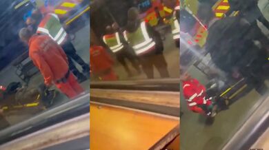 Záchranář umravňující agresivního bezdomovce