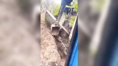 Lžíce stroje zachránila dělníka před zřícením zdi